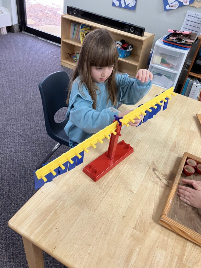 Child engaging in a Montessori activity in classroom